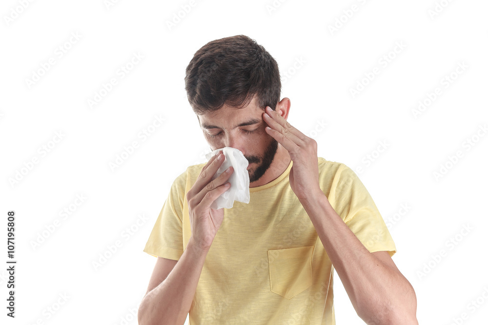 Portrait of a man sneezing with a handkerchief, isolated on whit