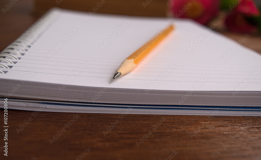 Notebooks and pensil with romantic pink flowers Notebooks and pensil with romantic pink flowers