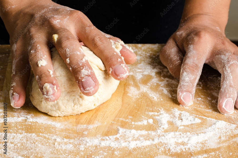 Kneading dough on wooden plate,bread cooking process