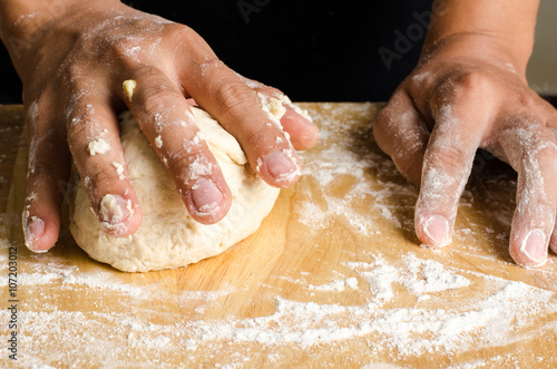 Kneading dough on wooden plate,bread cooking process