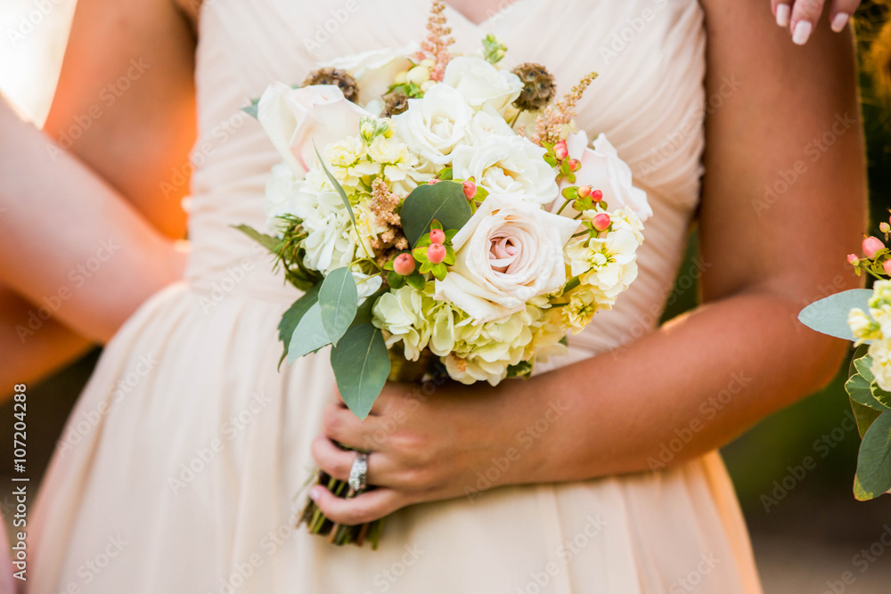 Bridesmaid holding beautiful pastel pink rustic bouquet. Bridesmaid holding beautiful pastel pink rustic bouquet.