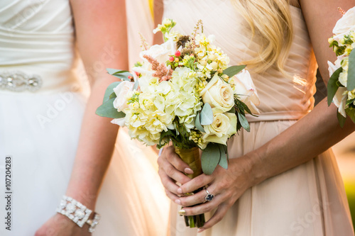 Bridesmaid holding beautiful pastel rustic bouquet.