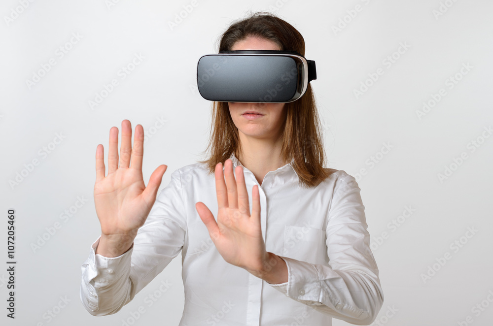 Woman wearing 3D viewer reaching for something Woman wearing 3D viewer reaching for something