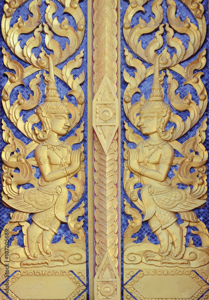 Thai temple door golden angle sculpture