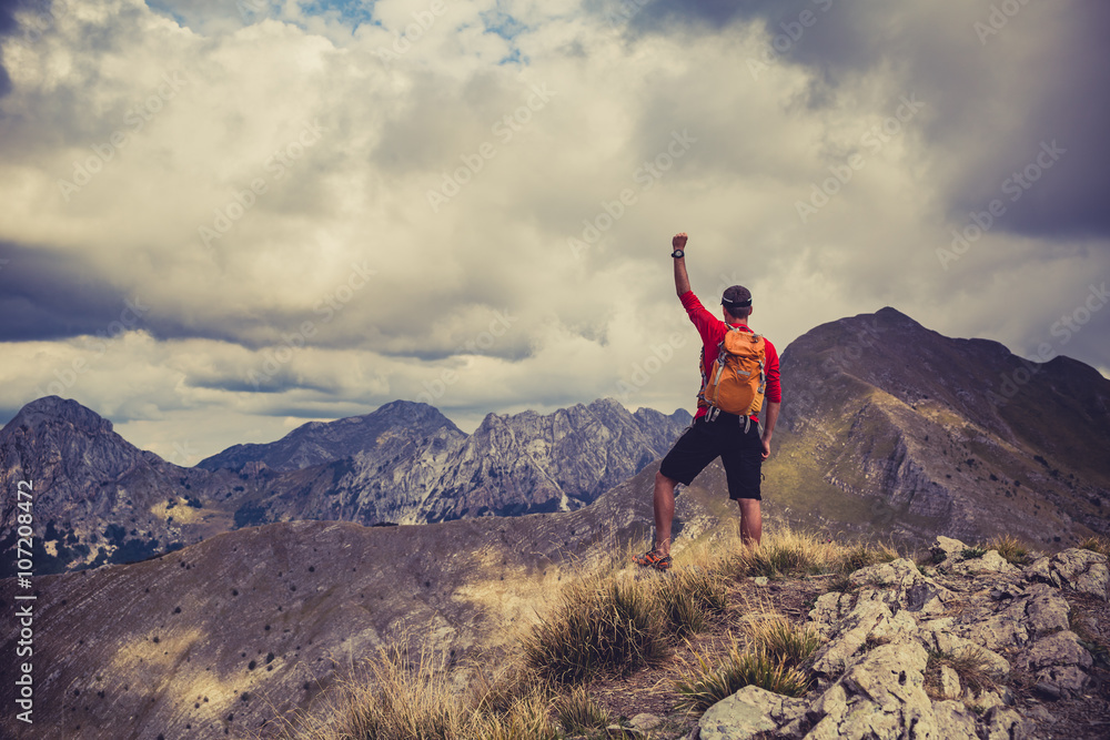 Hiking success, man runner in mountains Hiking success, man runner in mountains
