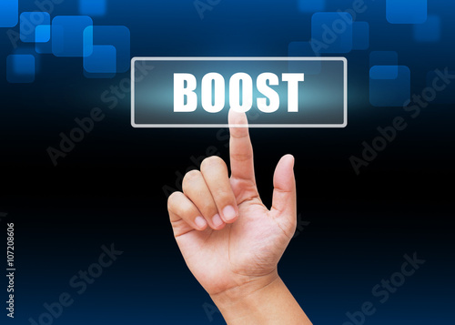 Hand pressing boost button with technology background
