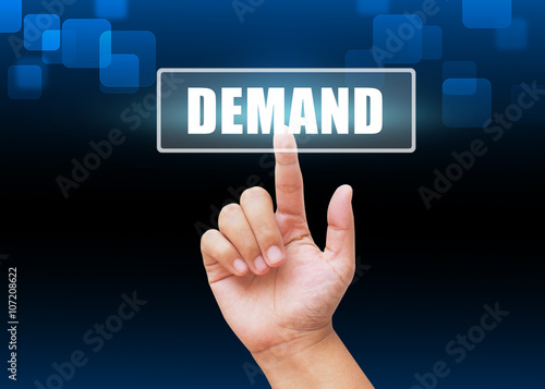 Hand pressing demand button with technology background