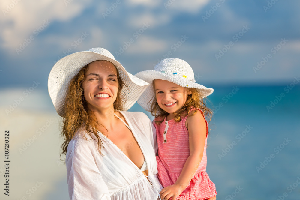 Portrait of mother and little daughter on the beach