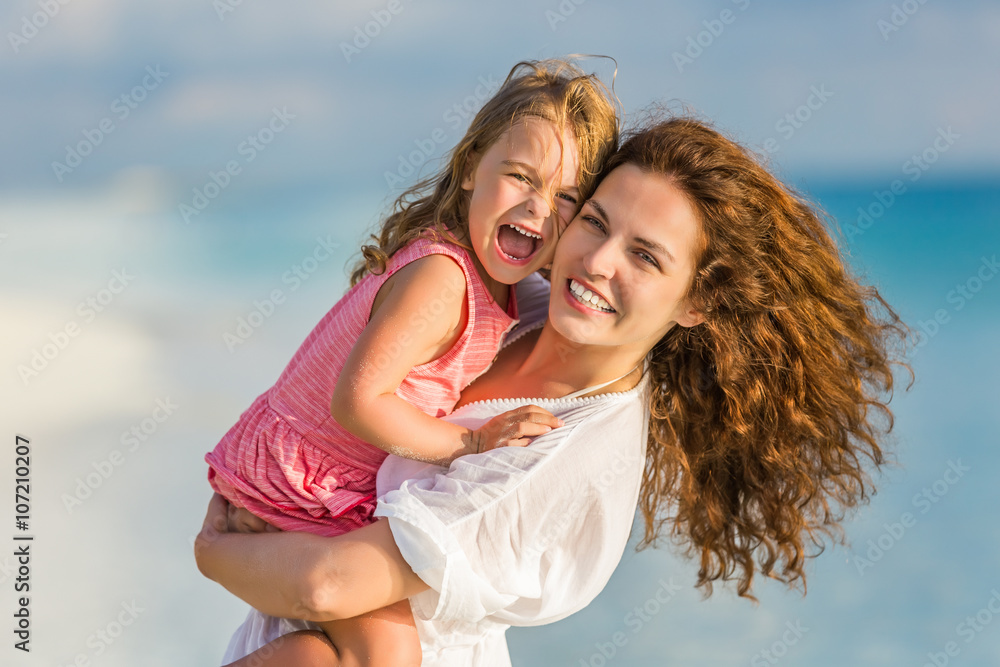 Portrait of mother and little daughter on the beach Portrait of mother and little daughter on the beach
