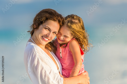 Portrait of mother and little daughter on the beach © sborisov