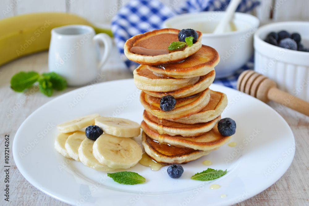 Pancakes for breakfast with honey and blueberries