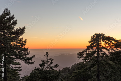 Mountain range with layer mist on evening glow background. Troodos, Cyprus. 
