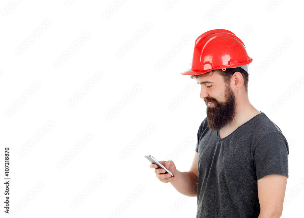 Young men with hipster look and red helmet looking the mobile Young men with hipster look and red helmet looking the mobile