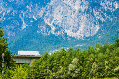 White Truck on the highway in European Alps.