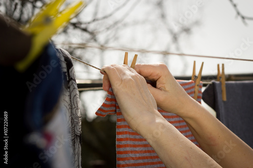 An old hand of active senior clothesline some clothes by wood p