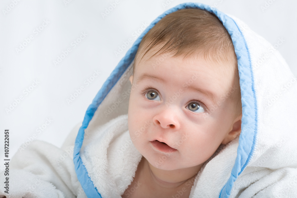 beautiful little baby with big eyes in white towel looking for something beautiful little baby with big eyes in white towel looking for something
