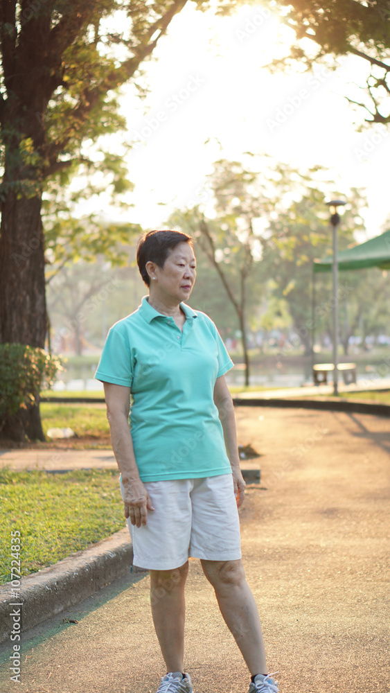 asian senior woman smile in sunshine with morning nature backgro asian senior woman smile in sunshine with morning nature backgro