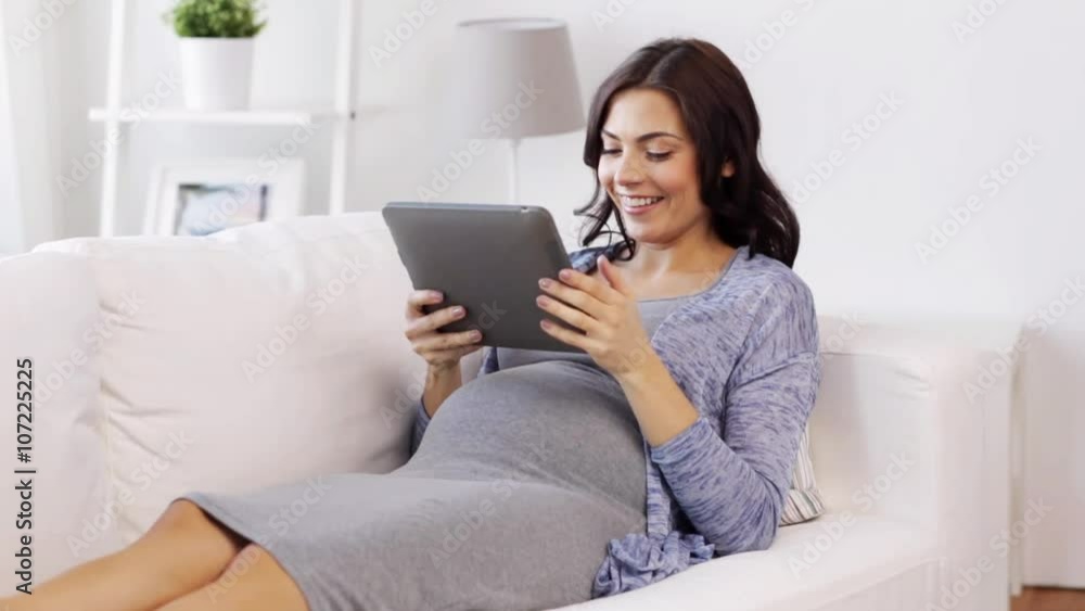 happy pregnant woman with tablet pc at home happy pregnant woman with tablet pc at home