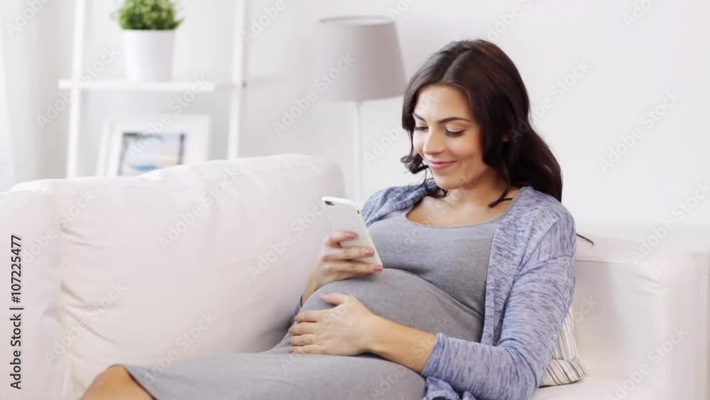 happy pregnant woman with smartphone at home happy pregnant woman with smartphone at home