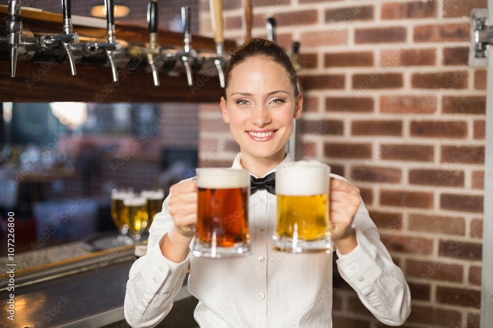 Female bartender holding beers Female bartender holding beers