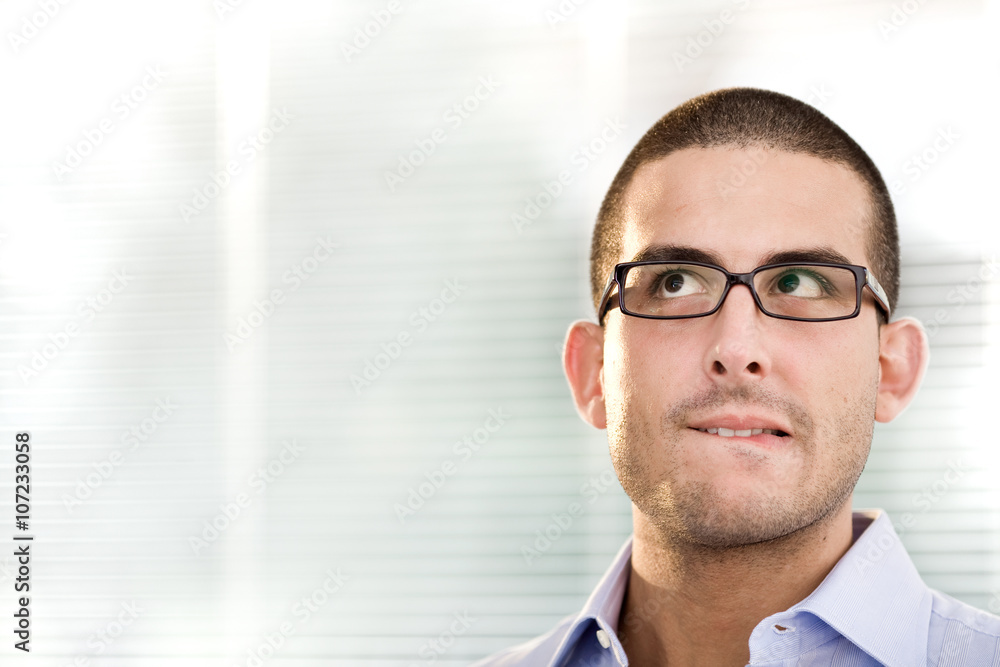 young doubtful businessman with glasses think at office young doubtful businessman with glasses think at office
