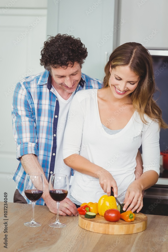 Smiling wife with husband in kitchen Smiling wife with husband in kitchen