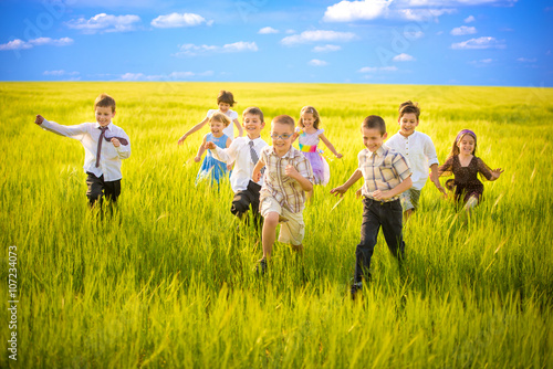 Happy Childhood Friends Running Together in Group © Marko Novkov