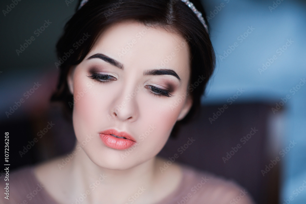Portrait of a young brunette woman in a beautiful dress with make-up and hairstyle, lifestyle, beauty Portrait of a young brunette woman in a beautiful dress with make-up and hairstyle, lifestyle, beauty