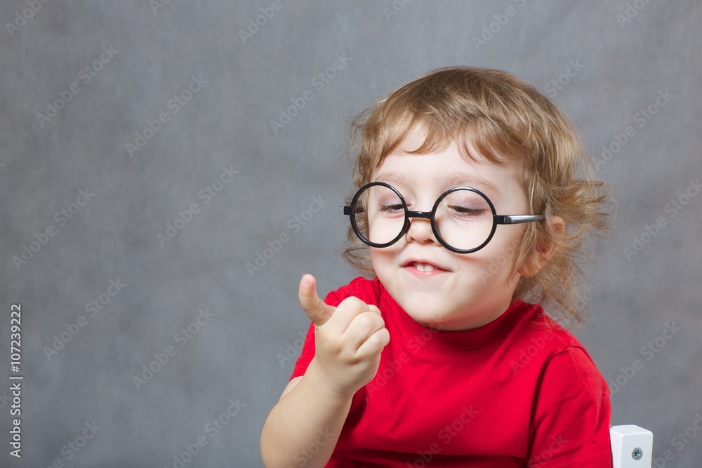 A boy of three years is showing his index finger A boy of three years is showing his index finger