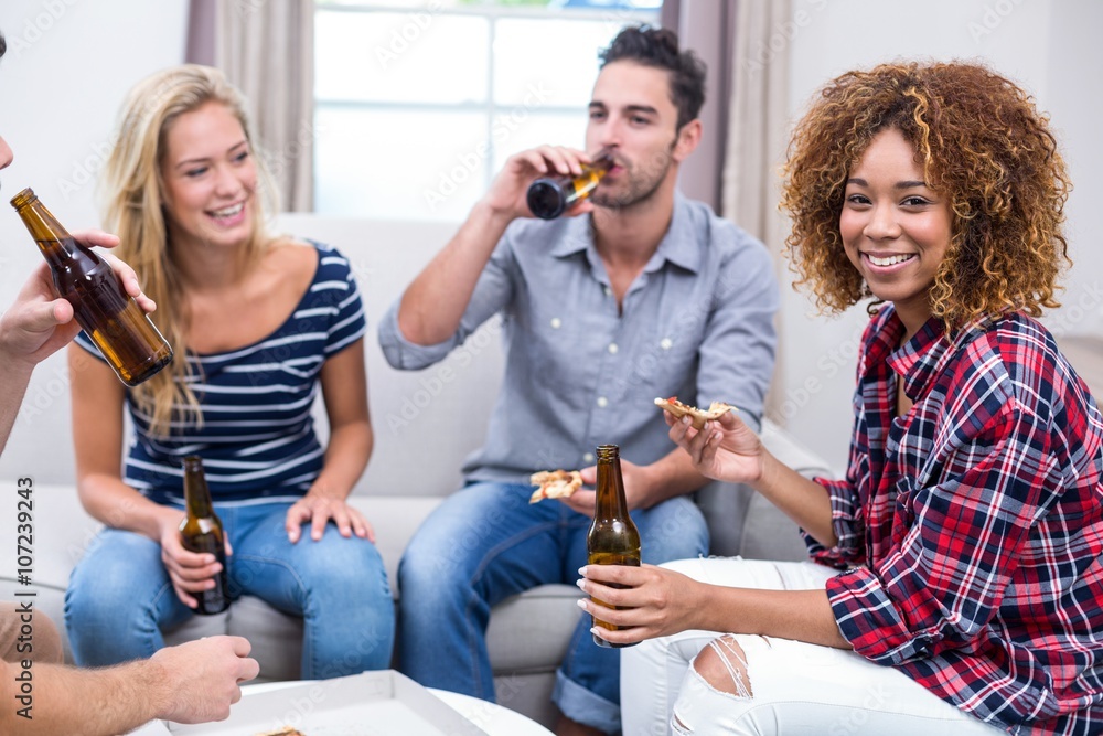 Young woman enjoying beer and pizza with friends Young woman enjoying beer and pizza with friends