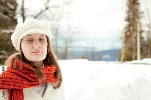 beautiful relaxed woman with red scarf in a snowy landscape portrait