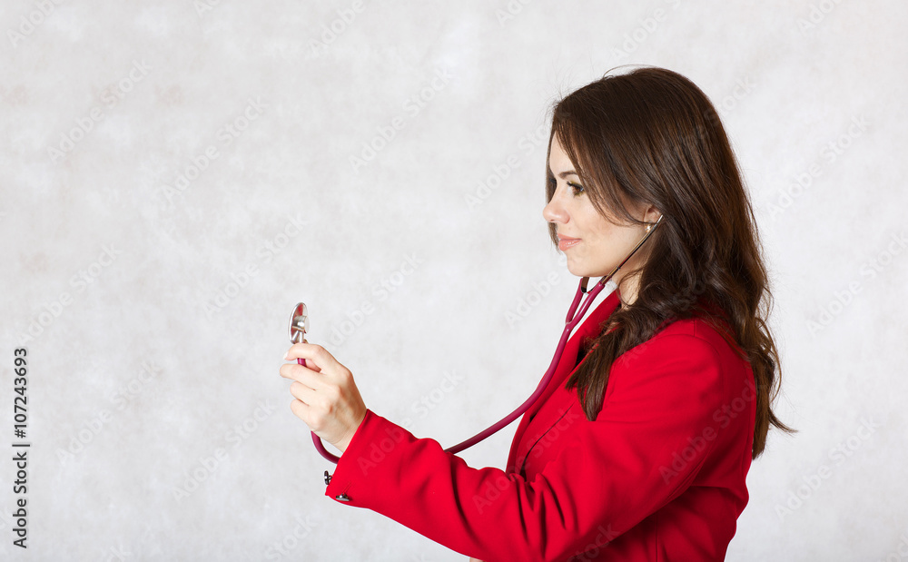 Naklejka premium Young woman with a stethoscope. Closeup