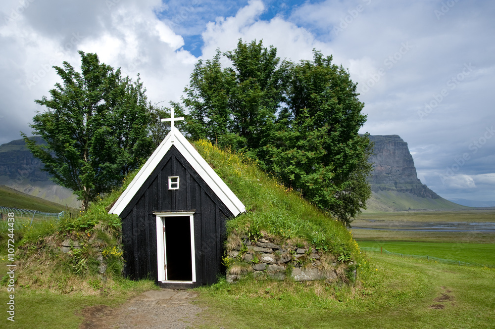 Old small wooden church of Nupstadur with grass on the roof, Iceland