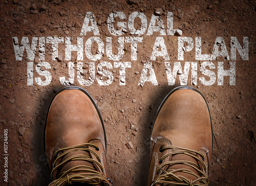 Top View of Boot on the trail with the text: A Goal Without a Plan Is Just a Wish photo