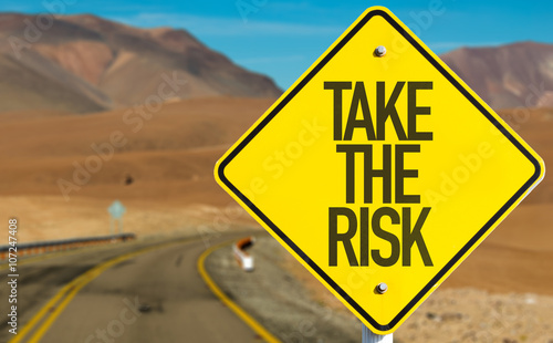 Take The Risk sign on desert road