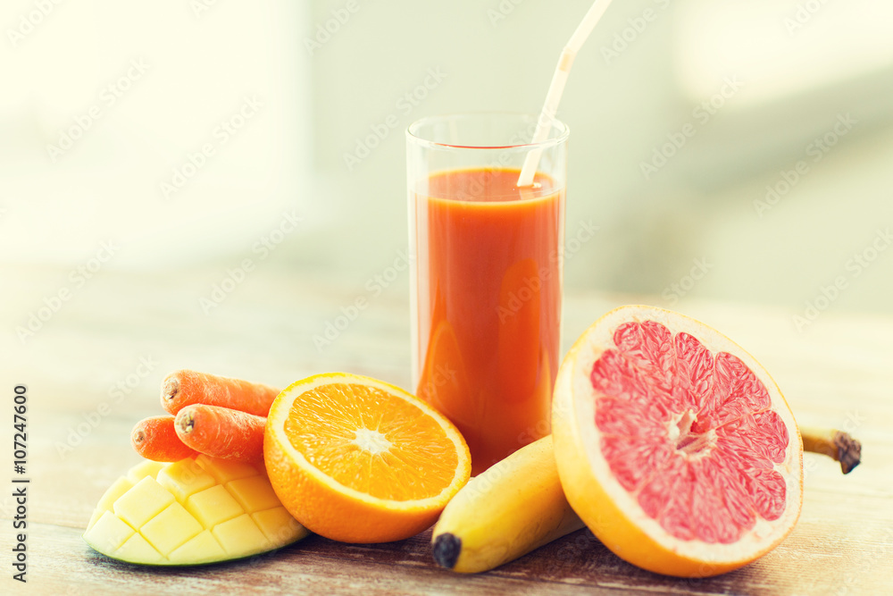 close up of fresh juice glass and fruits on table close up of fresh juice glass and fruits on table