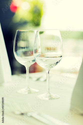 close up of two wine glasses on restaurant table