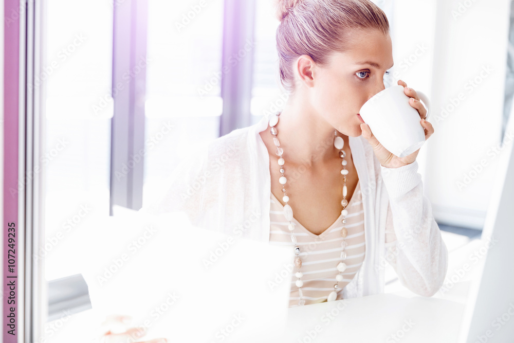 Attractive office worker sitting at desk Attractive office worker sitting at desk