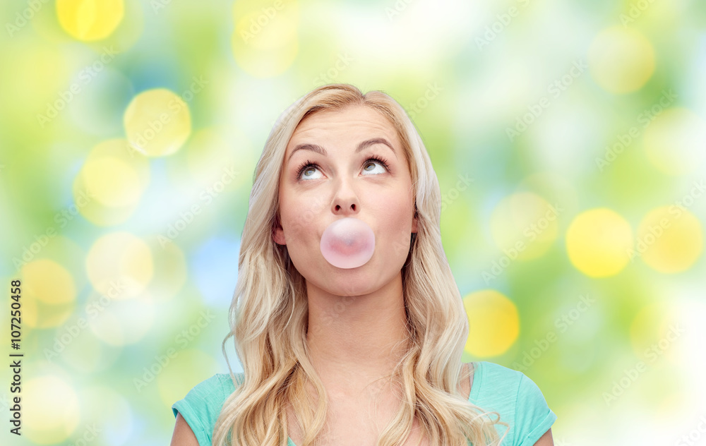 happy young woman or teenage girl chewing gum happy young woman or teenage girl chewing gum