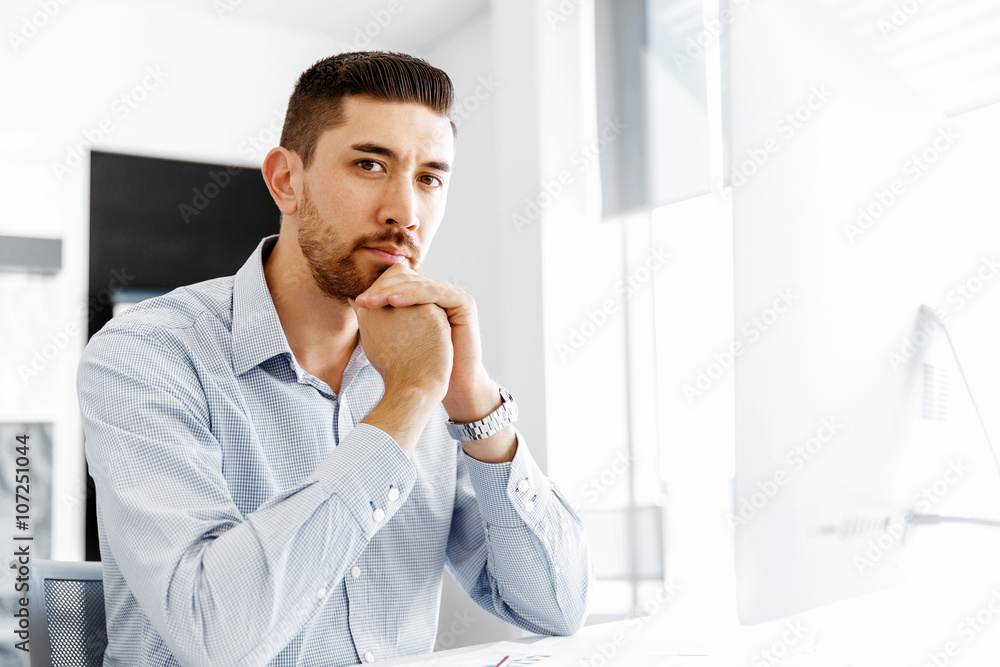 Male office worker sitting at desk