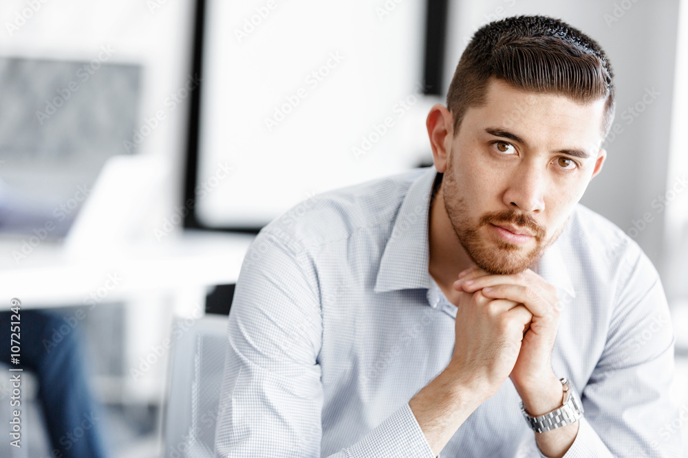 Attractive office worker sitting at desk Attractive office worker sitting at desk