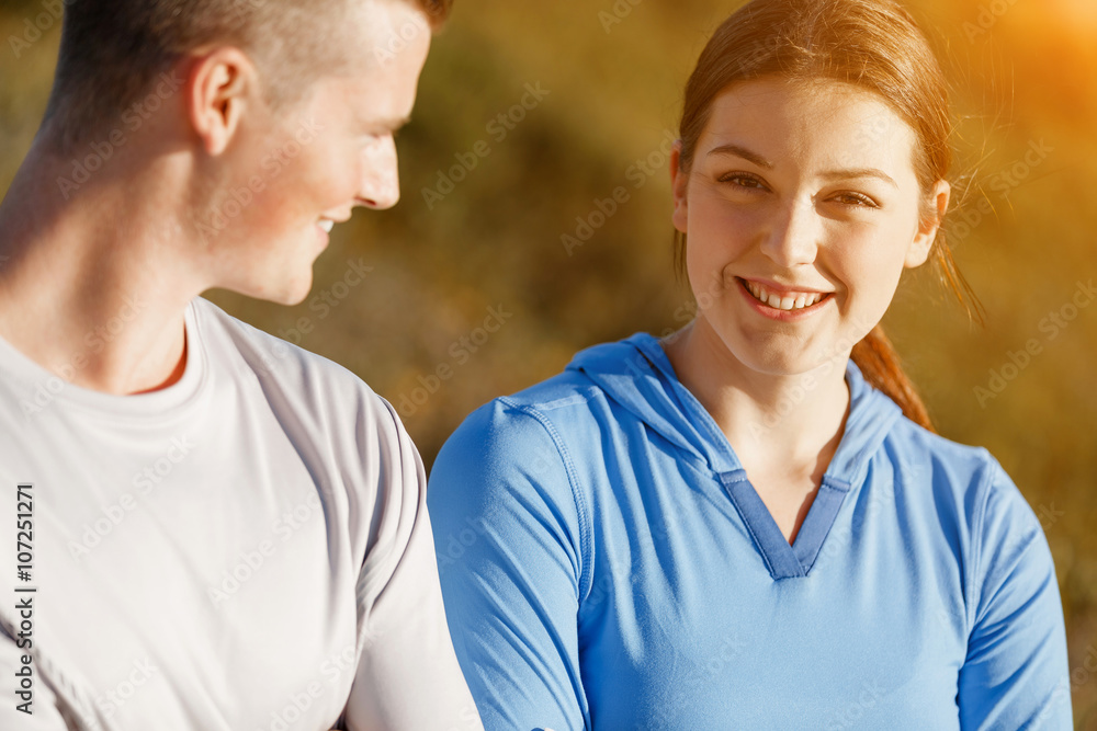 Young couple on beach in sportwear Young couple on beach in sportwear