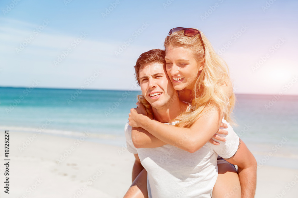 Portrait of man carrying girlfriend on his back