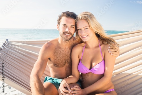 Smiling couple sitting in hammock