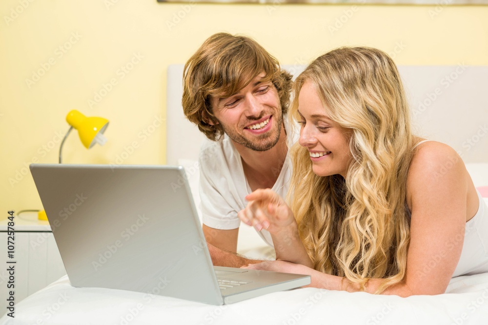 Cute couple using laptop