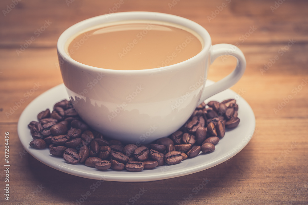 Coffee cup and saucer on a wooden table. Dark background. Coffee cup and saucer on a wooden table. Dark background.