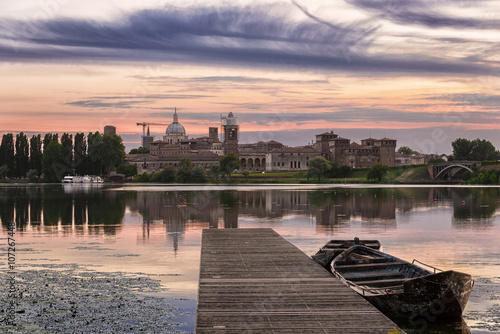 Mantua skyline at sunset with pier and boat