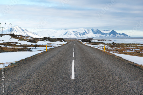 Winter landscape with asphalt road and mountains, Iceland