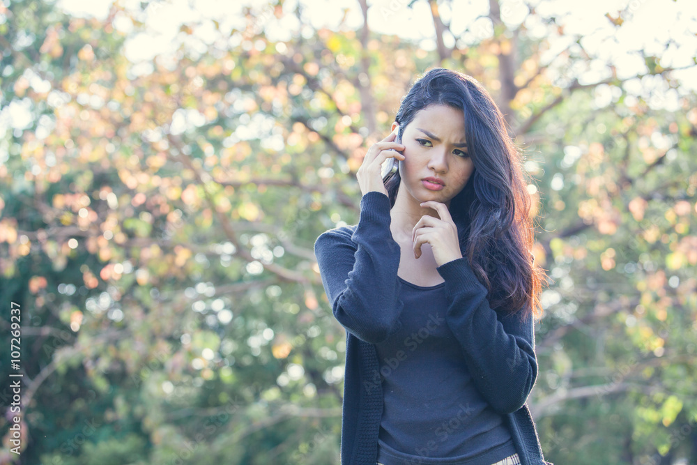Portrait unhappy confuse young woman talking on mobile phone loo Portrait unhappy confuse young woman talking on mobile phone loo