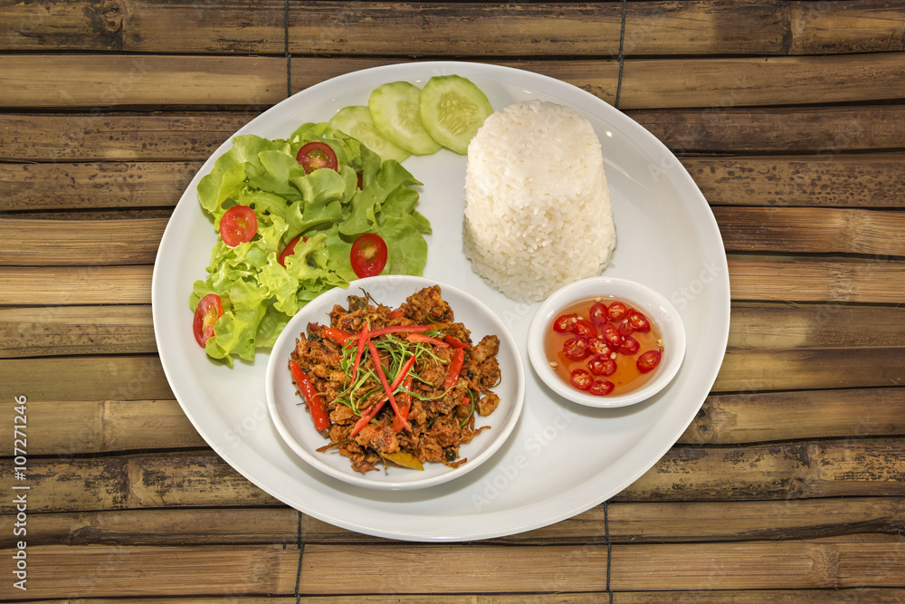 Fried pork spicy with yellow curry paste on dish thai style food Fried pork spicy with yellow curry paste on dish thai style food